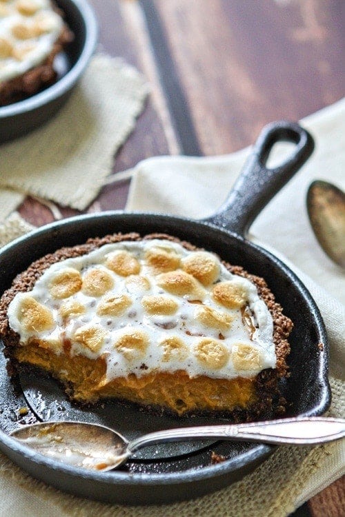 A mini sweet potato tart in a cast iron skillet. A serving is missing. 