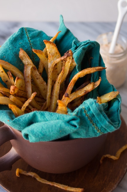 seasoned fries in mug with blue towel