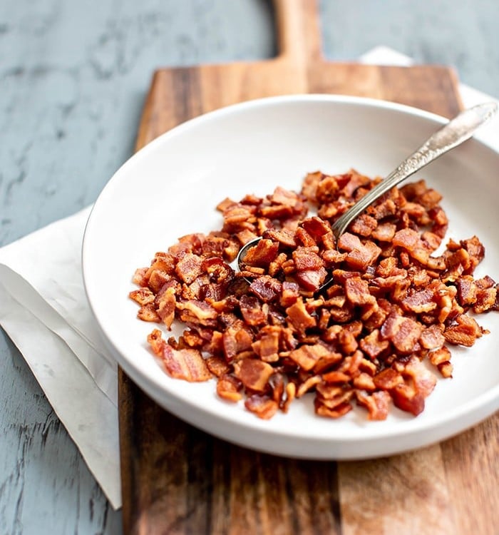 bowl of cooked bacon on cutting board