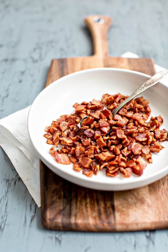 bowl of cooked bacon on cutting board