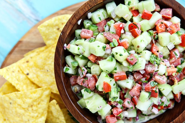Cucumber Salsa in wood bowl next to tortilla chips