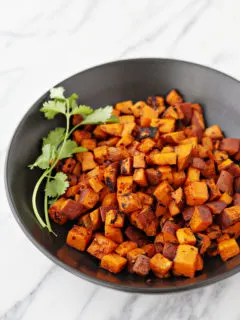 photo of grilled sweet potatoes in a black bowl