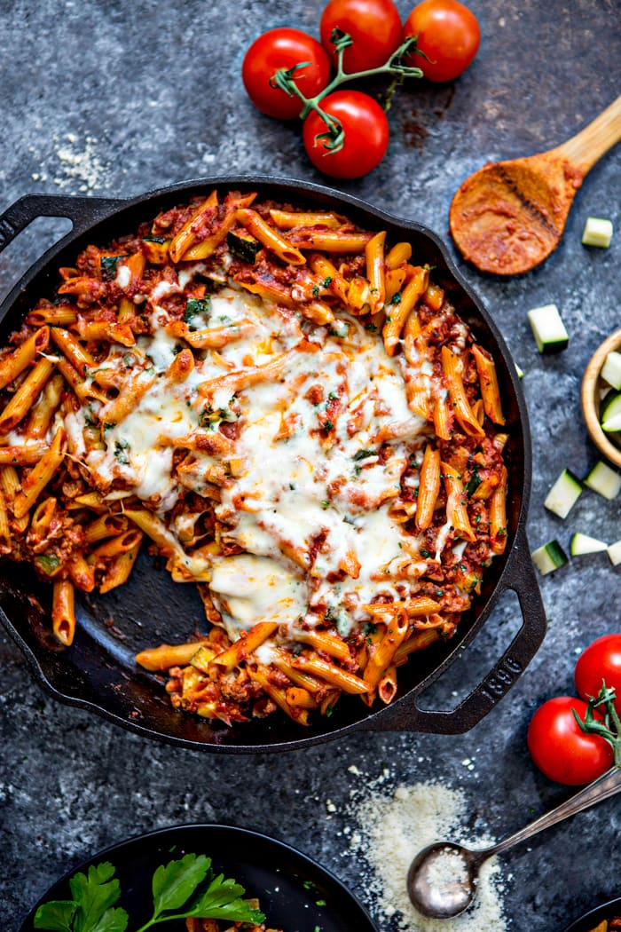 overhead shot of a cast iron skillet with baked ziti