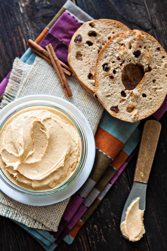 photo of pumpkin cream cheese in a bowl next to a bagel