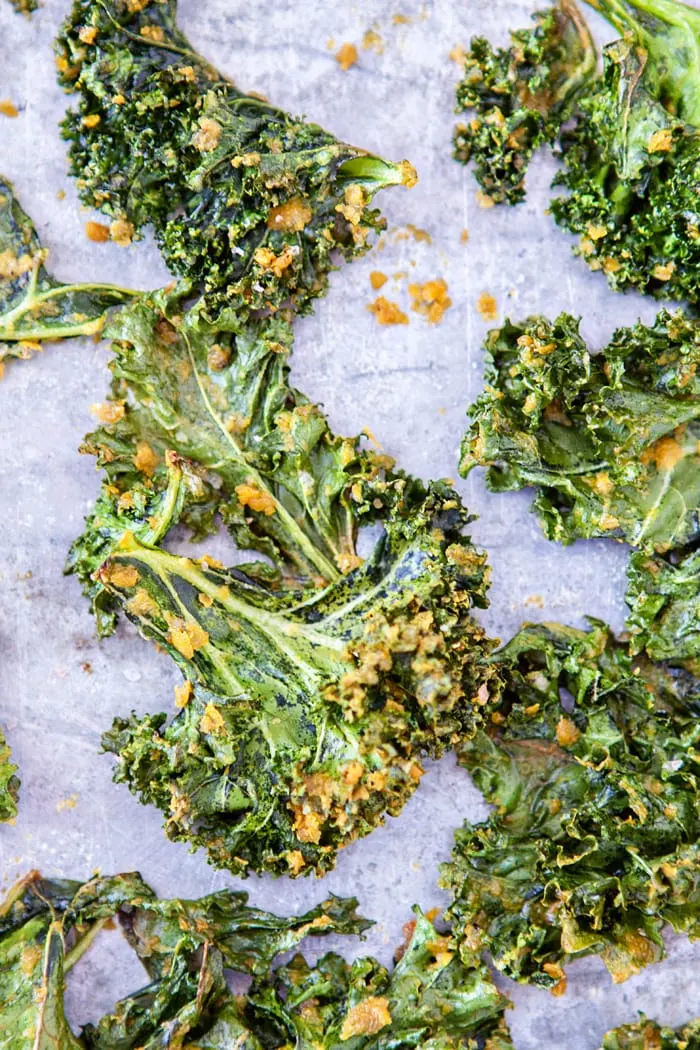 overhead photo of baked kale chips on a sheet pan