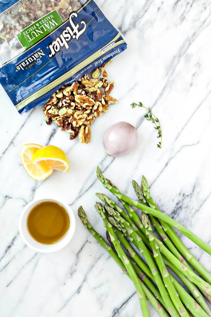 ingredients for oven roasted asparagus on marble countertop