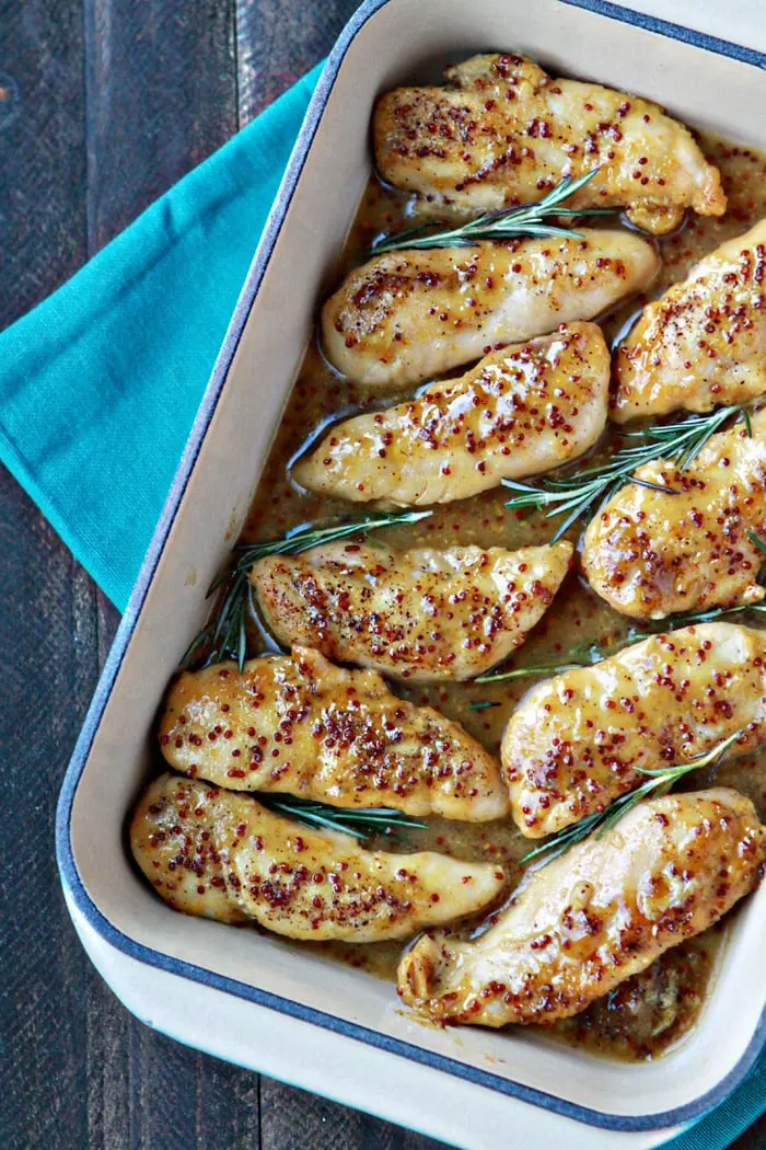 overhead shot of baked honey mustard chicken in blue baking dish