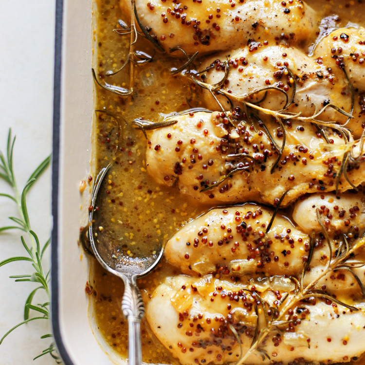 photo of honey mustard chicken in a white baking dish