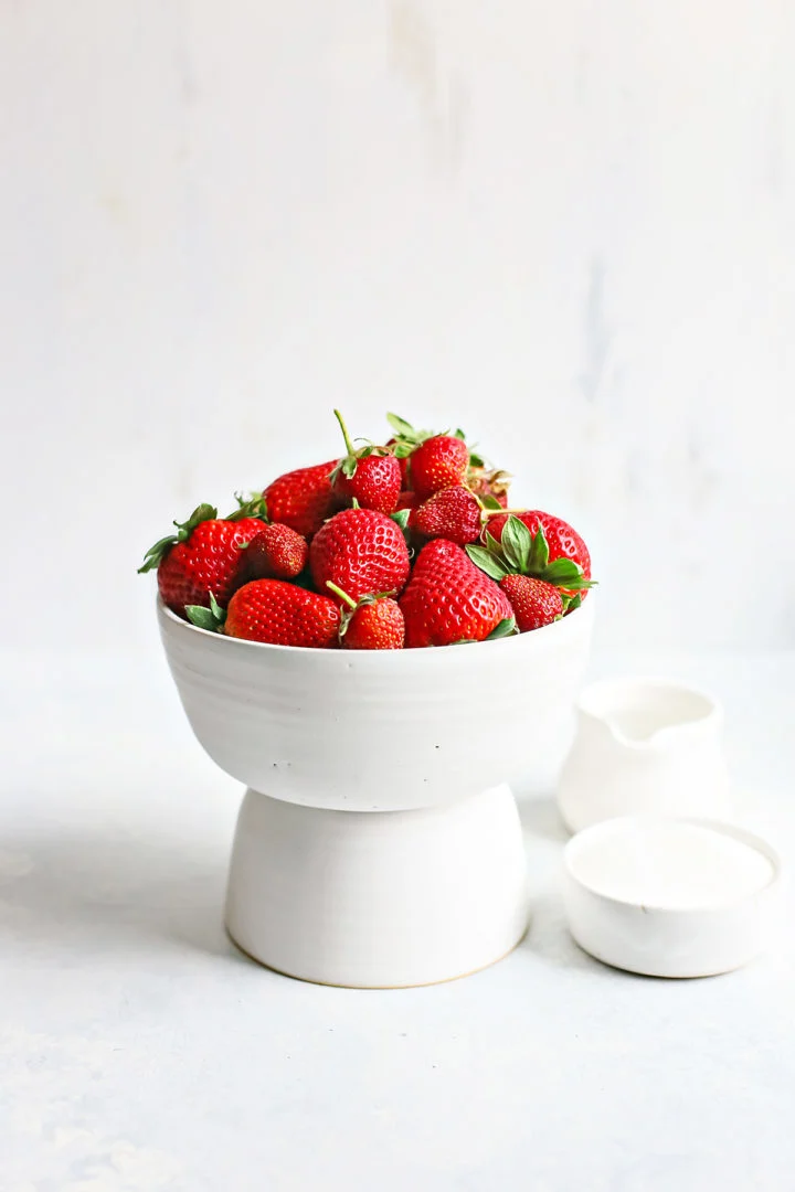 fresh strawberries in a white bowl