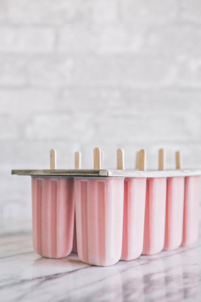 Creamy Strawberry Lemonade Popsicles in popsicle mold