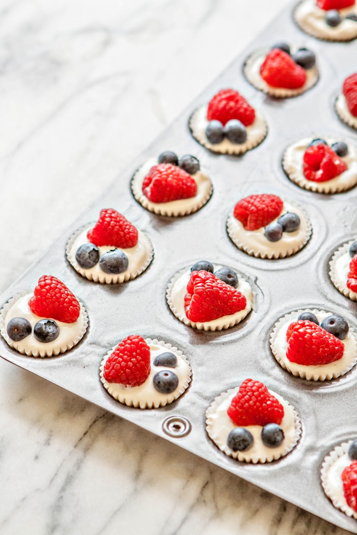 mini muffin tin with yogurt and berries