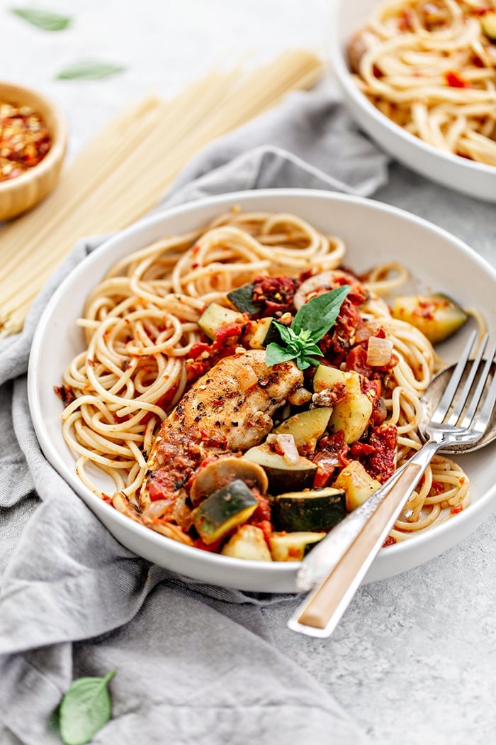 white bowl with pasta and chicken