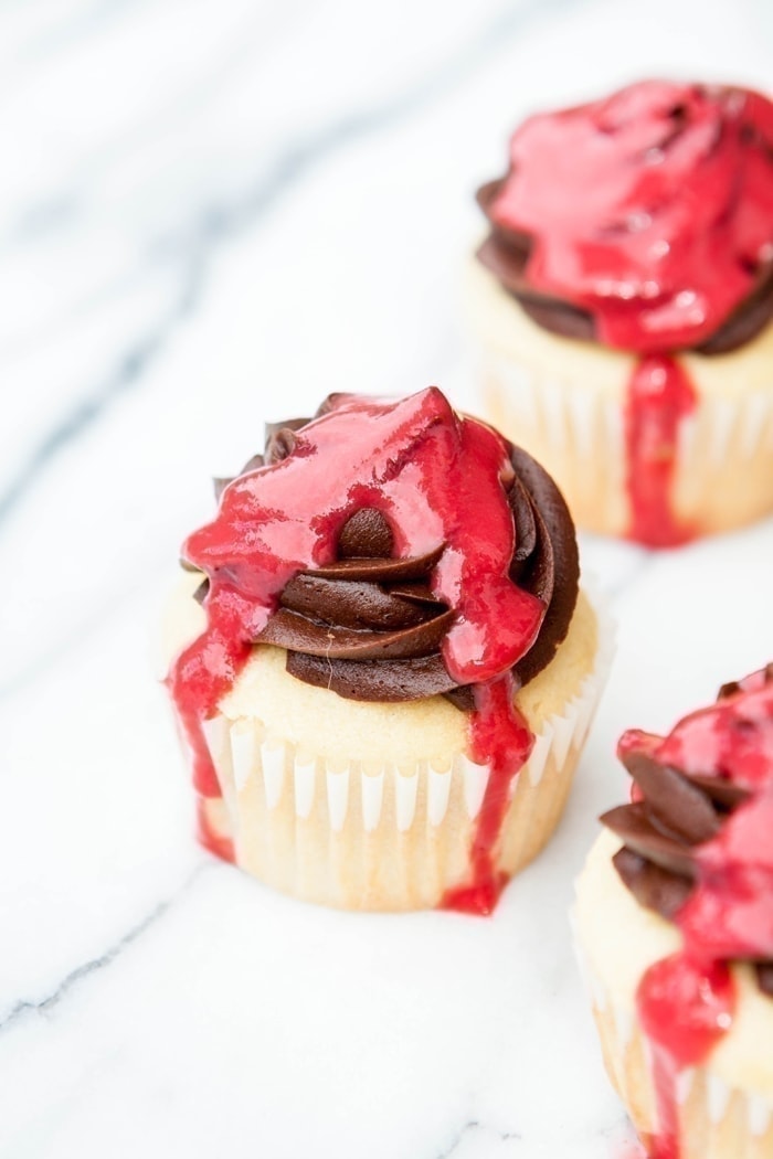 vanilla-cupcakes-with-chocolate-buttercream-and-fresh-raspberry-sauce