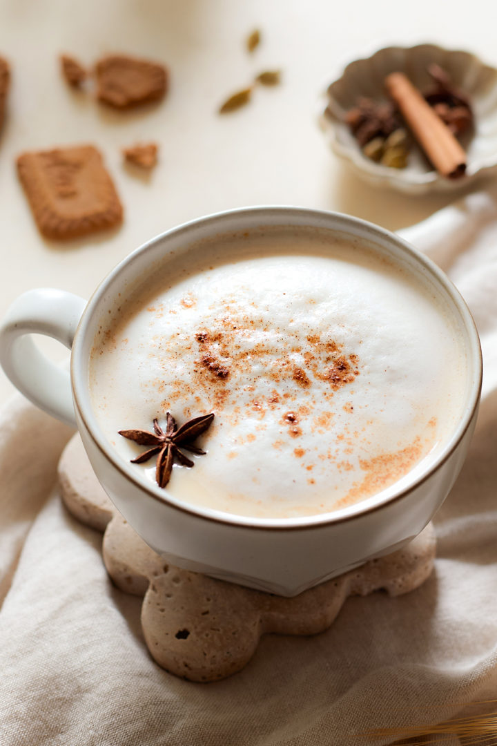 pumpkin chai tea latte topped with milk foam and spices 
