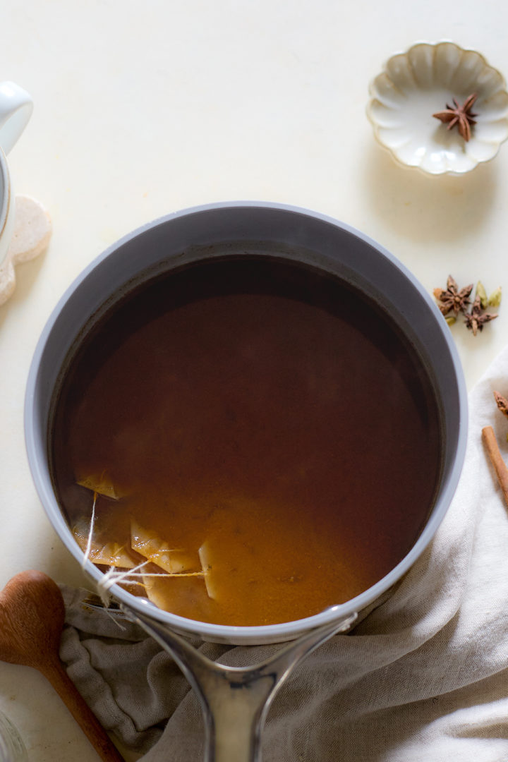 Black tea bags steeping in a saucepan 