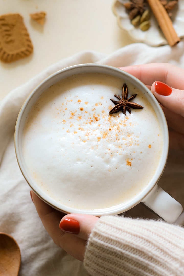 A pumpkin chai latte made with real pumpkin, garnished with milk foam and star anise. 