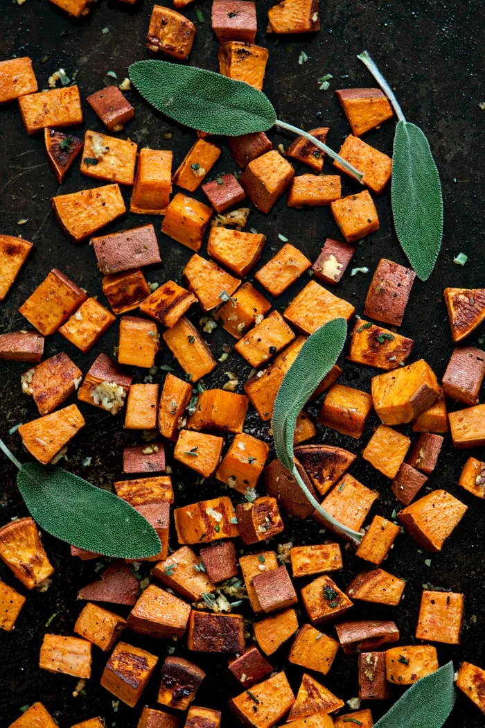 photo of Roasted Sweet Potato Cubes with Garlic and Sage on baking sheet