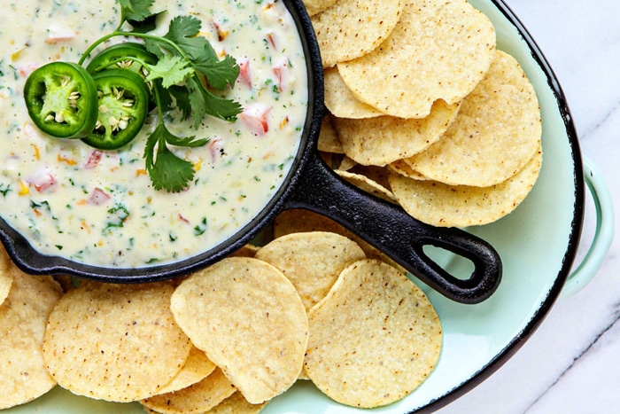 queso blanco dip in small skillet with tortilla chips