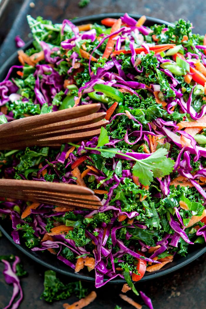 Cilantro Lime Slaw in serving bowl with wooden salad tongs