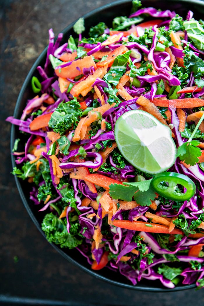 Cilantro Lime Kale Slaw in large bowl with lime wedge on top