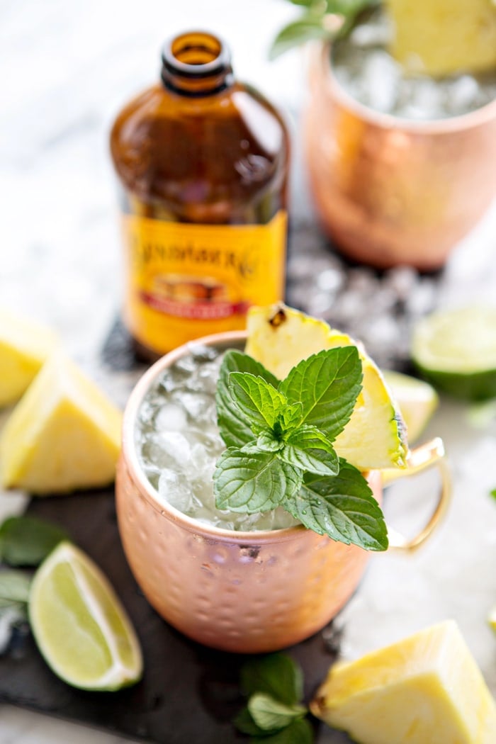 pineapple mint moscow mule in front of bottle of ginger beer