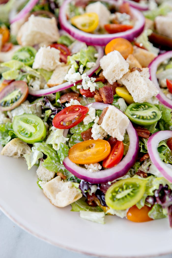 close up of a white platter with a blt salad on it 