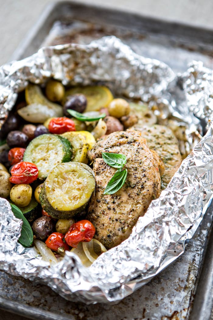 a photo of Pesto Pork Chops in foil packets with Summer Vegetables
