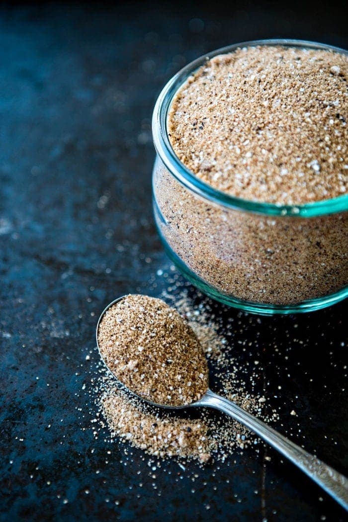 bbq dry rub in glass container next to spoon