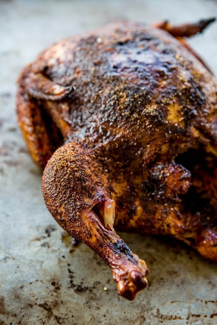 smoked chicken on baking sheet with bbq rub