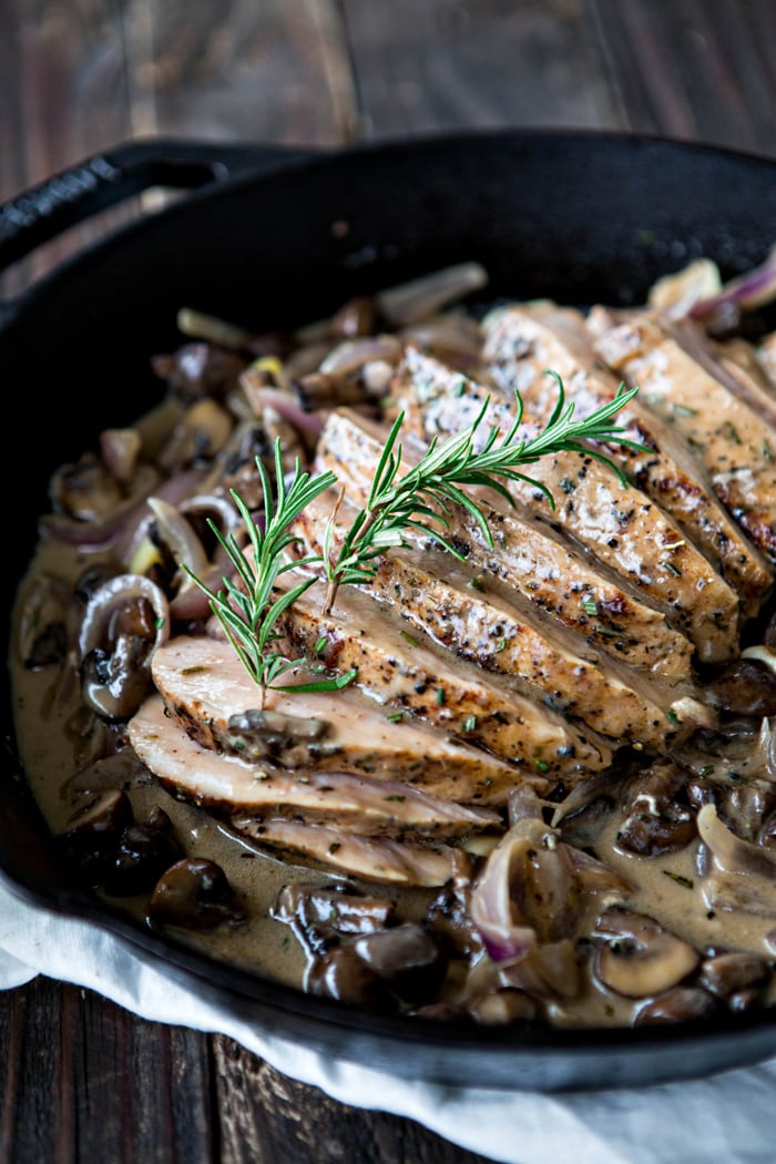 sliced roast pork marsala with creamy mushroom marsala sauce in cast iron skillet