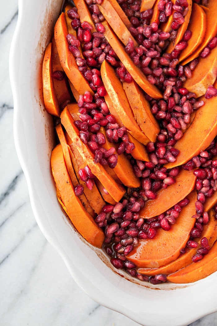 In this Sliced Sweet Potato Casserole, sweet potato slices are baked in a spiced orange maple glaze and sprinkled with juicy, bright pomegranate arils. It's a gorgeous, colorful Thanksgiving side dish that is a little bit more on the healthier side without sacrificing flavor.