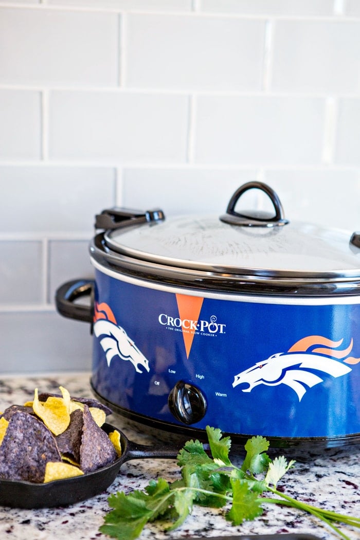 photo of a crock pot on a counter with crock pot queso dip cooking inside