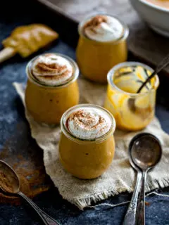 photo of pumpkin pudding in jars with whipped cream