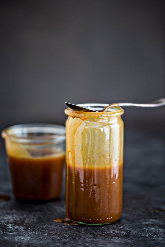 two glass jars of salted caramel sauce