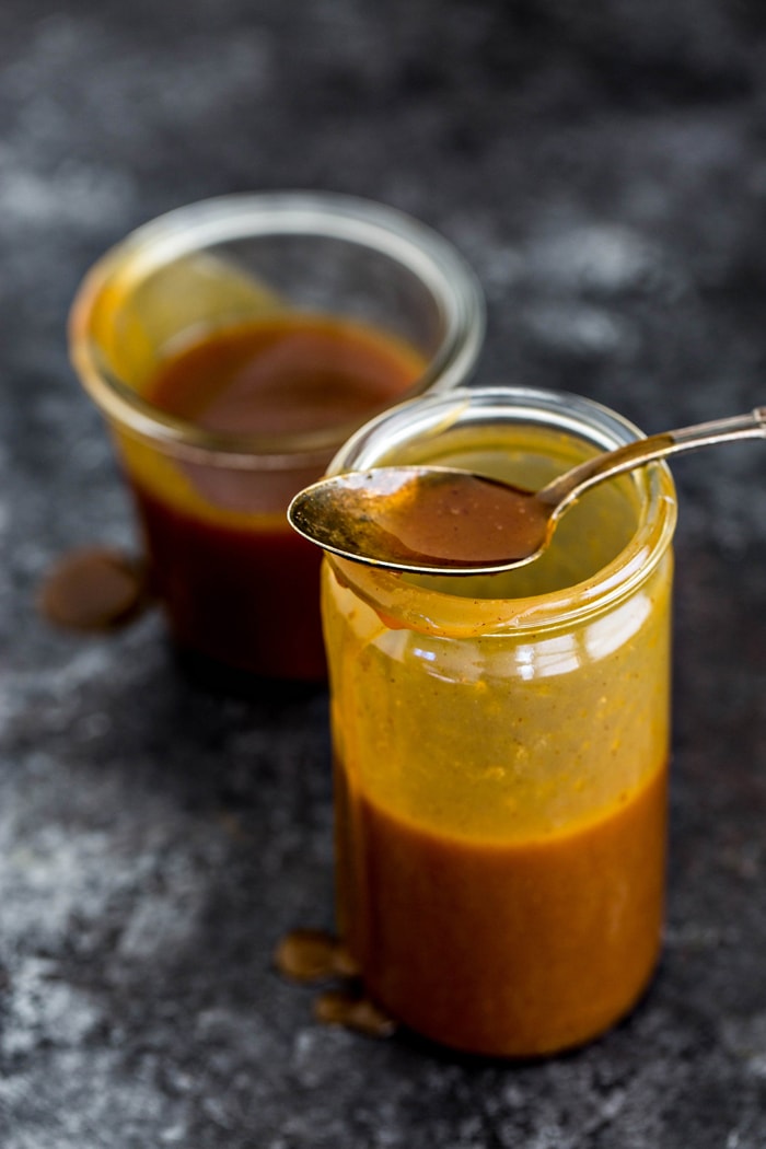 two glass jars of salted caramel sauce