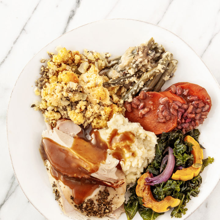 overhead photo of a white plate with slices of Traeger smoked turkey