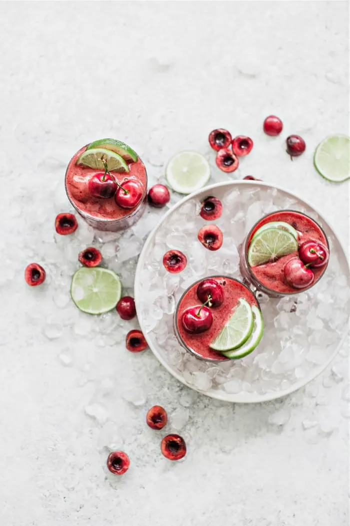 overhead images of cherry limeade slushes in a bowl with ice