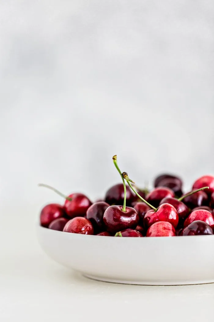 fresh cherries in a white bowl