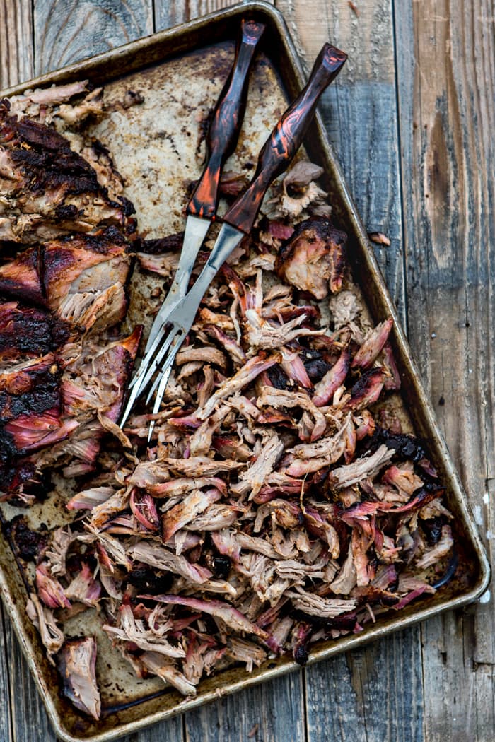 overhead shot of baking sheet with shredded smoked pulled pork made from a traeger smoked pork recipe