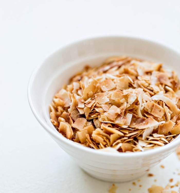 toasted coconut in a white bowl