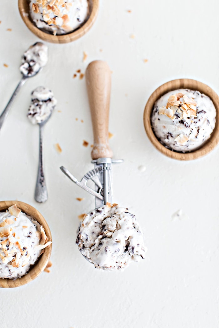 overhead shot of 3 wooden bowls of ice cream with 2 spoons