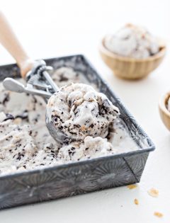 square container of ice cream with ice cream scoop and two bowls