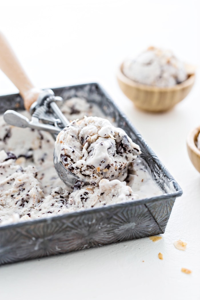 square container of ice cream with ice cream scoop and two bowls