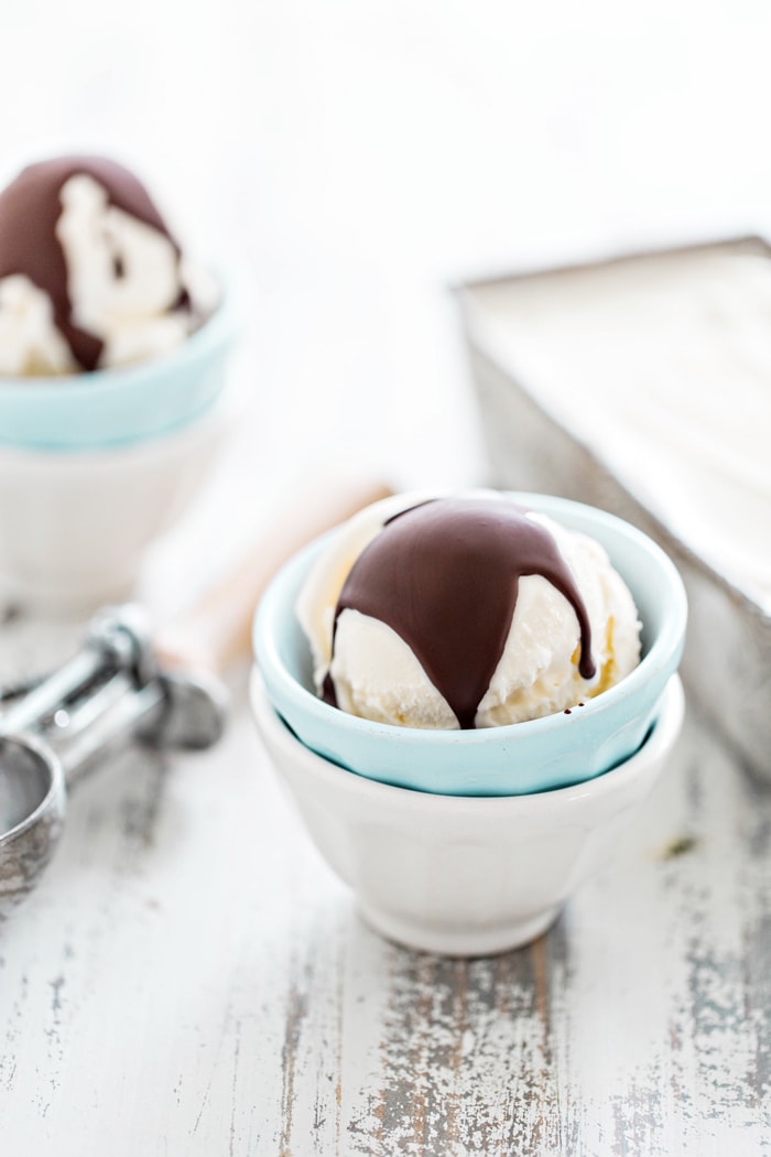 two bowls of vanilla ice cream with homemade magic shell chocolate topping