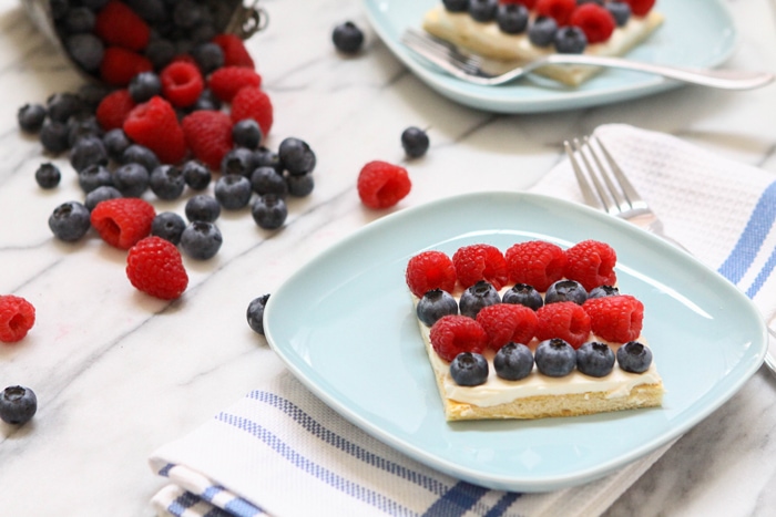 picture of fruit pizza with rows of raspberries and blueberries