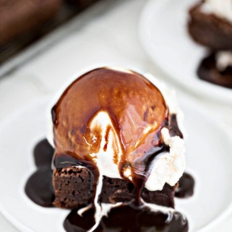 brownie on plate with ice cream and hot fudge