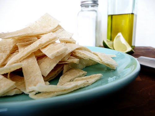 A blue plate piled high with tortilla strips