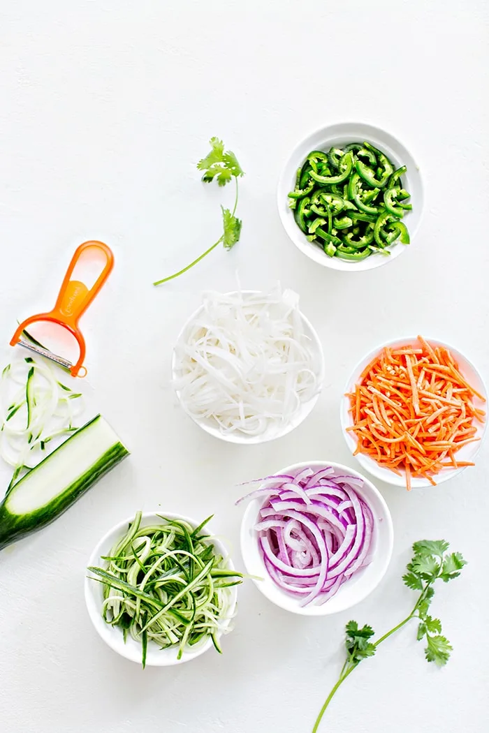 julienne cut vegetables on a white background