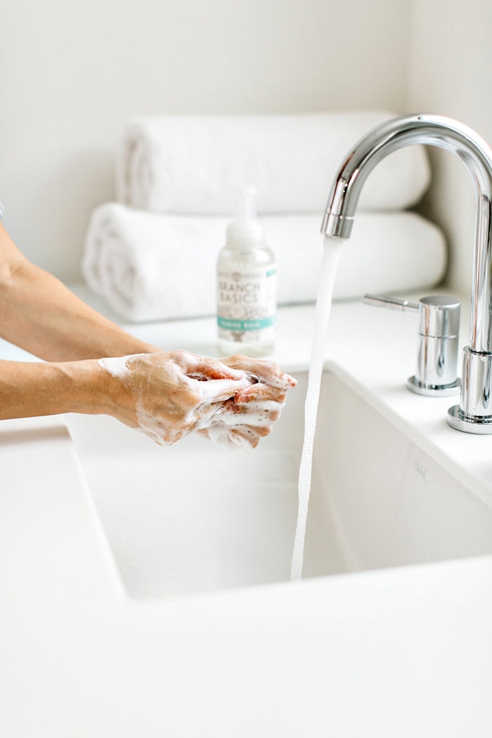woman washing hands with branch basics non toxic cleaner foaming hand soap (includes a branch basics coupon code in the post)