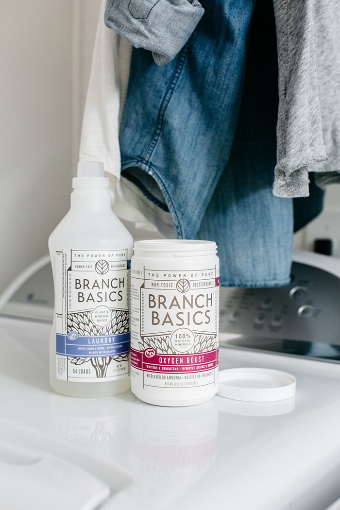 branch basics non toxic laundry cleaners on top of a washing machine (includes a branch basics coupon code in the post)